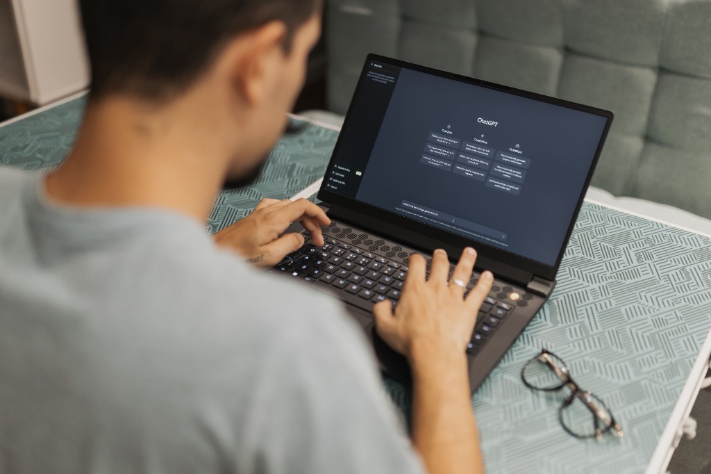 Person using a laptop with an AI chat interface